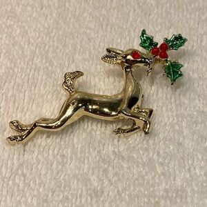 Gold tone leaping reindeer with mistletoe brooch pin